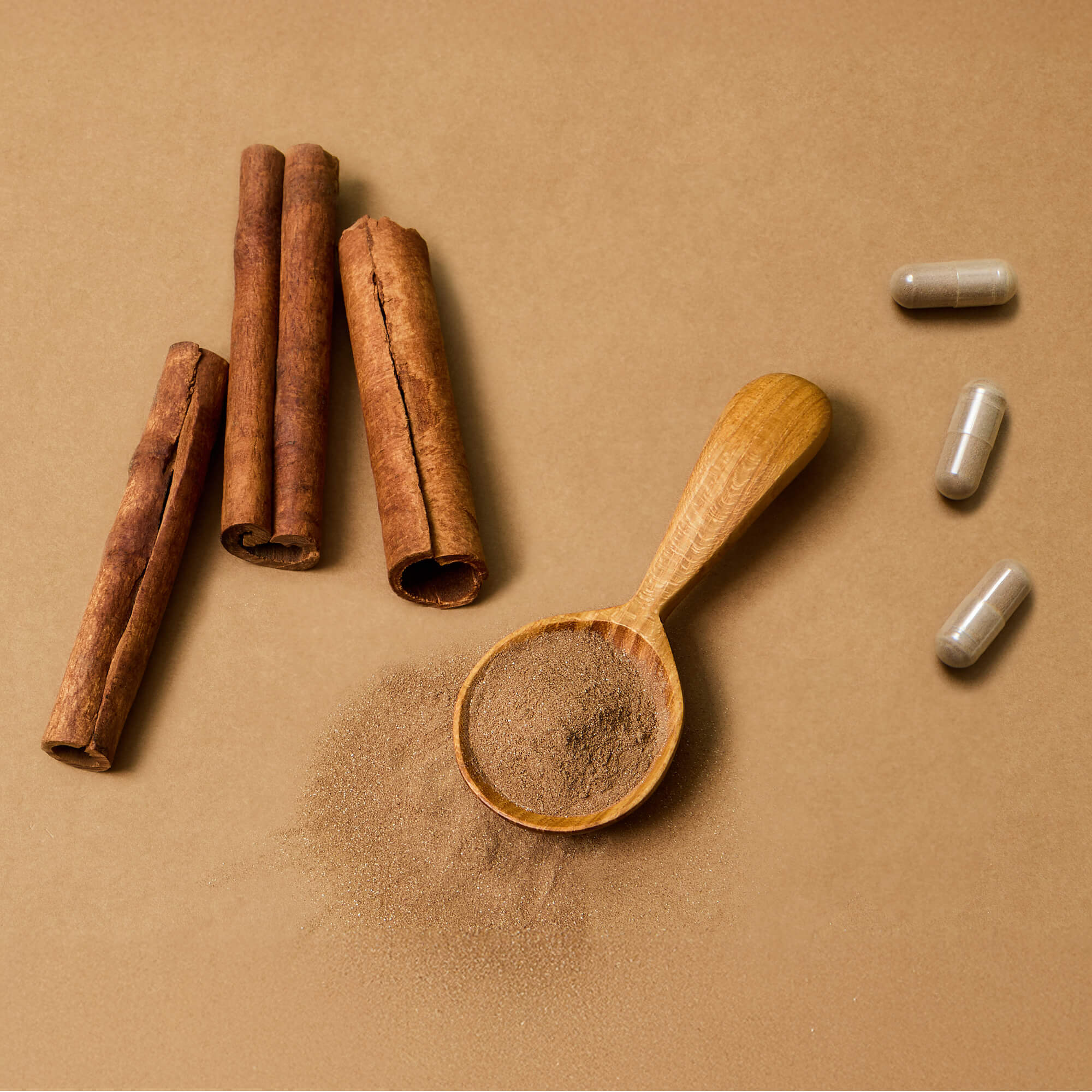 A side-by-side image of Ceylon cinnamon sticks, Ceylon cinnamon powder and Illuminate Labs Ceylon Cinnamon Extract capsules, visually explaining the process of extraction from whole plant to potent dietary supplement